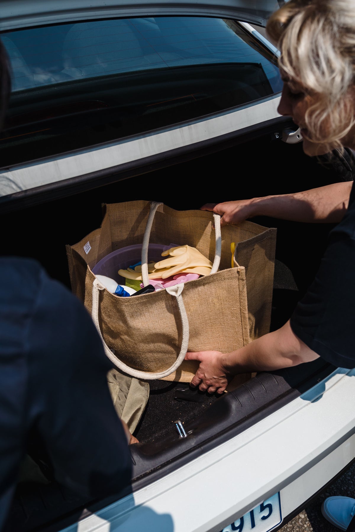 Loading a collapsible organizer box into the boot of a car