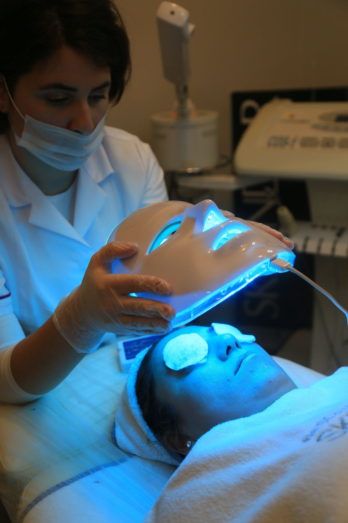 Blue LED light therapy face mask being fitted during a facial treatment