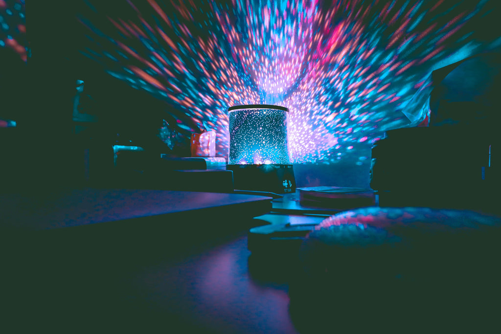 Galaxy night-sky projector casting colorful light in a dark room