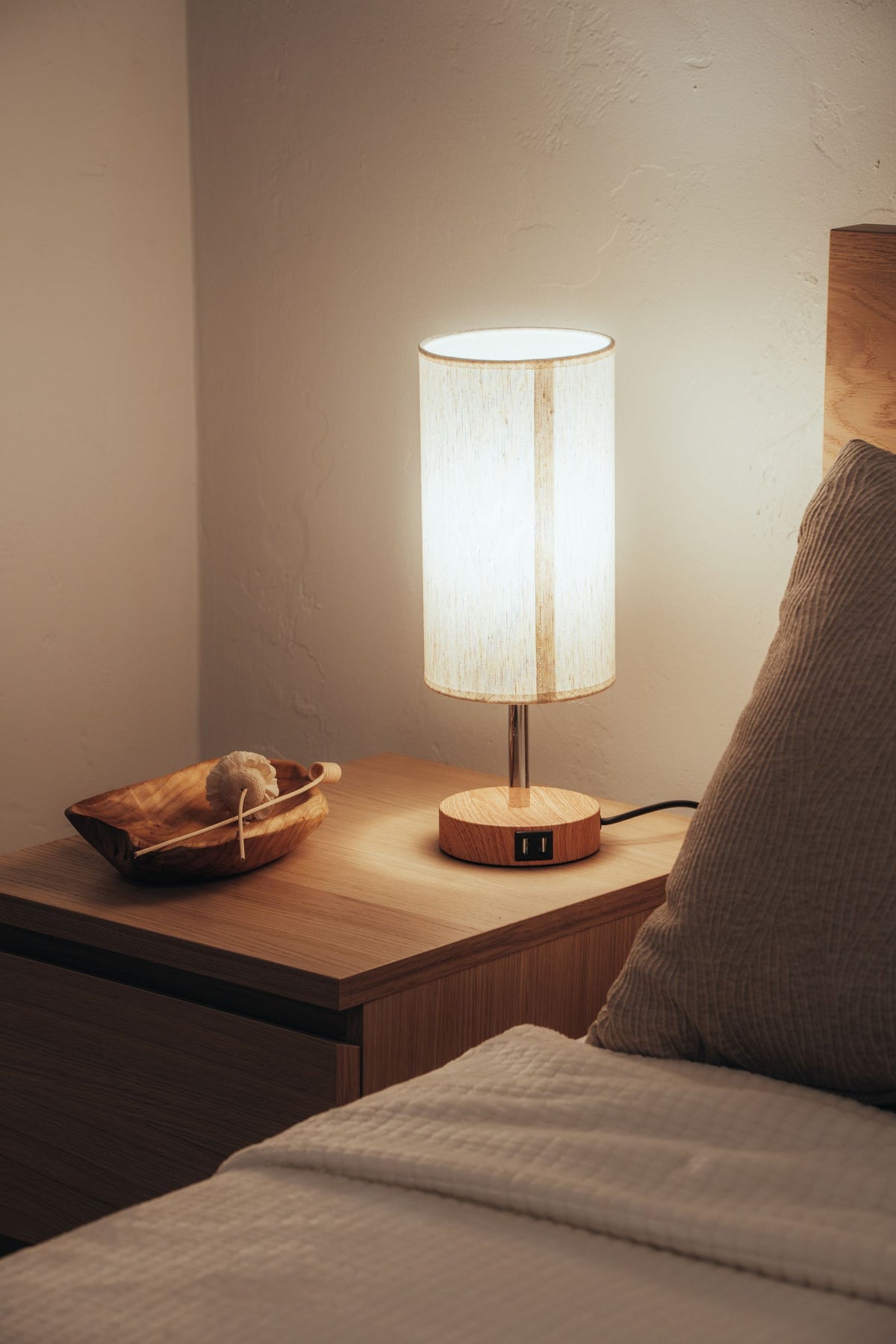 Glowing warm lamp on nightstand