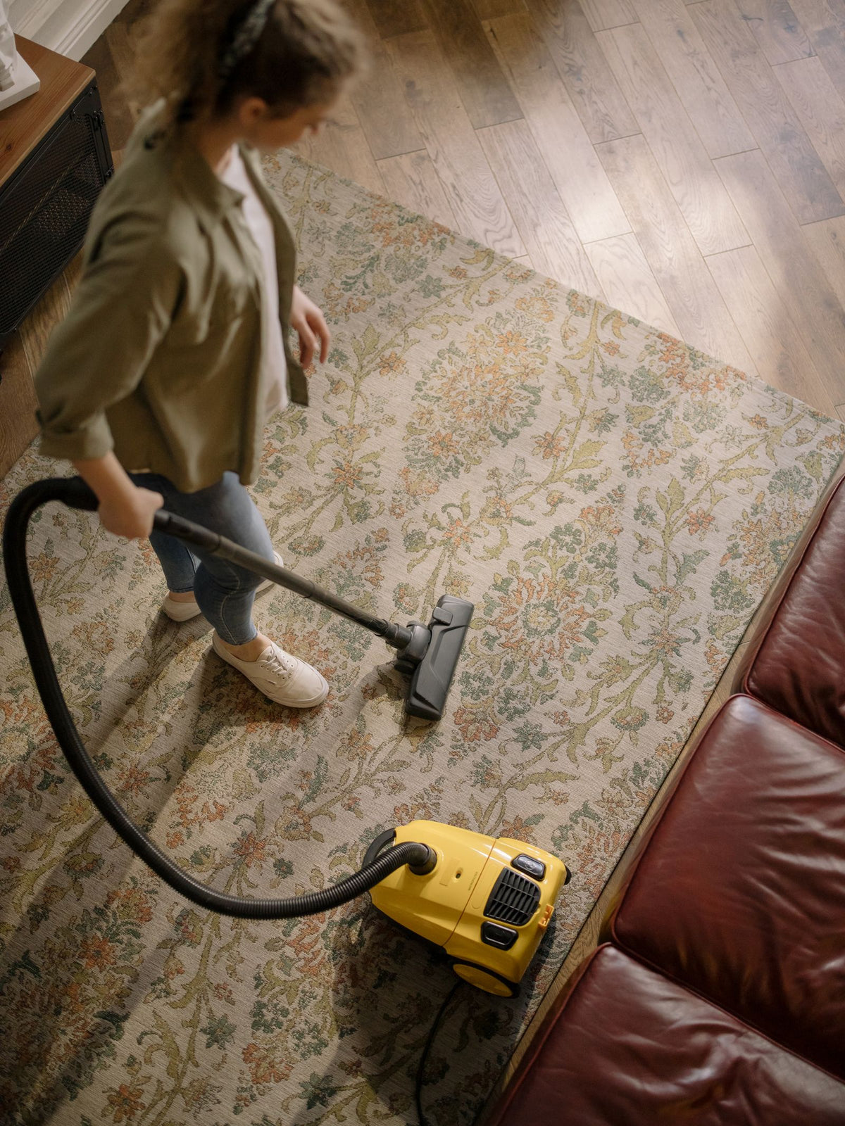 Person holding handheld vacuum cleaner for car cleaning