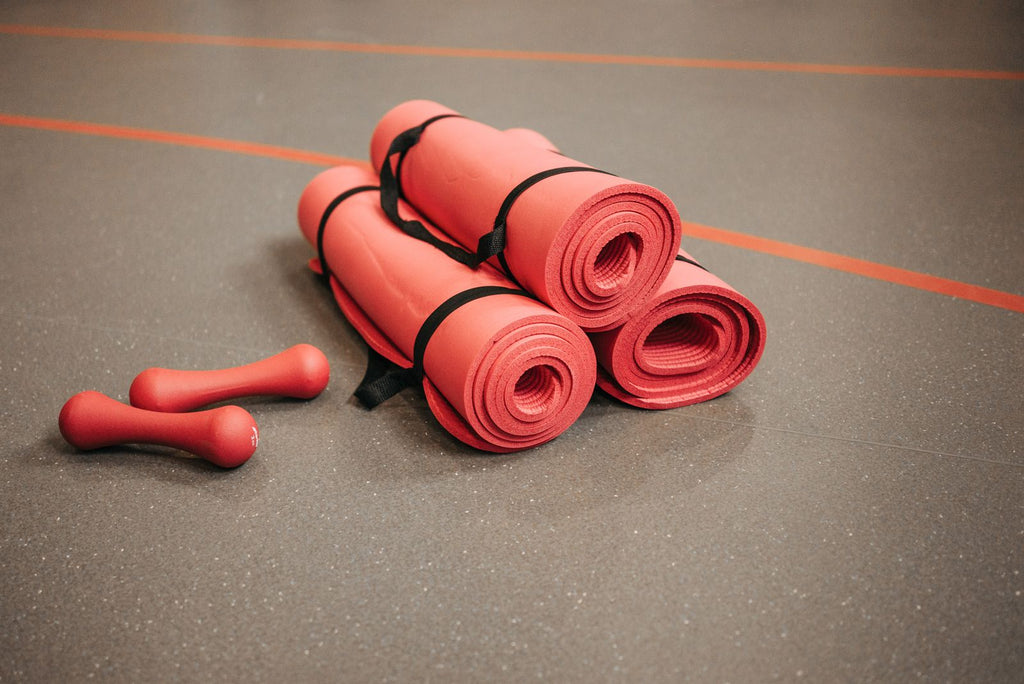 Rolled yoga mats in gym setting