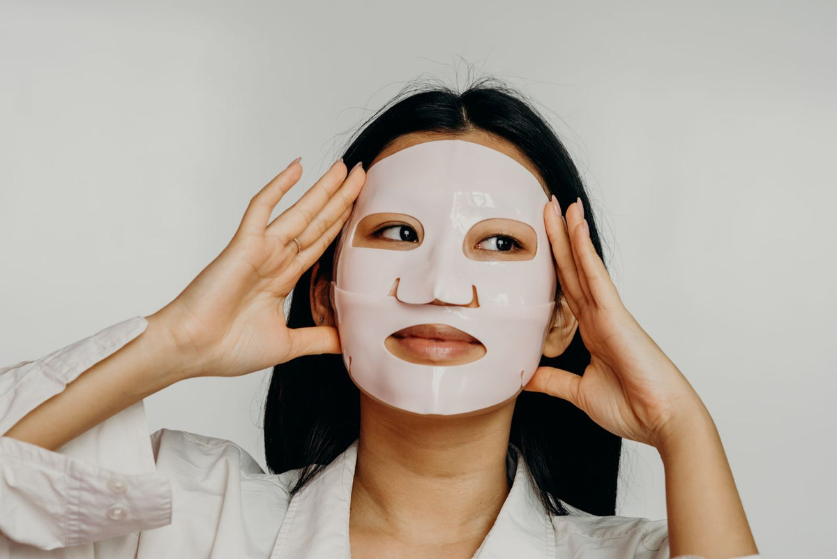 Woman with a facial sheet mask on