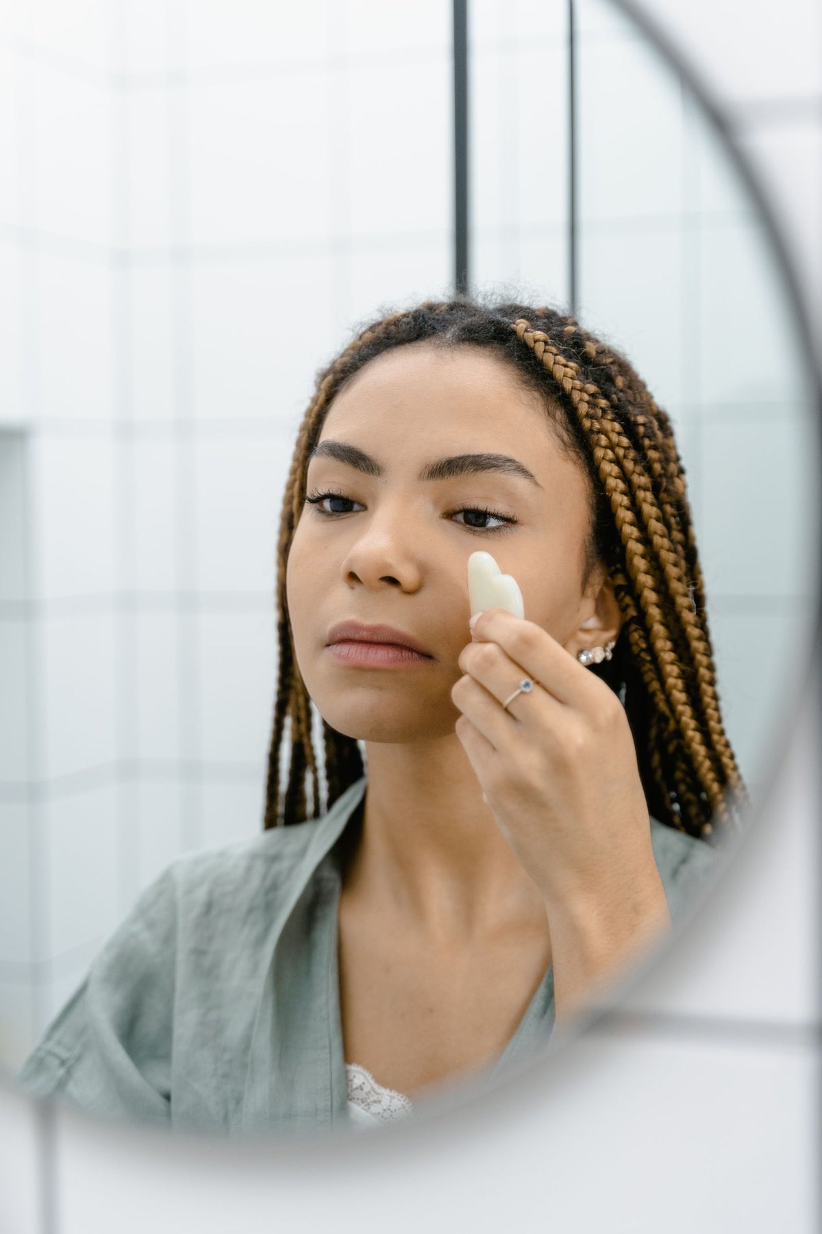 Woman using a silicone facial cleansing brush skincare tool