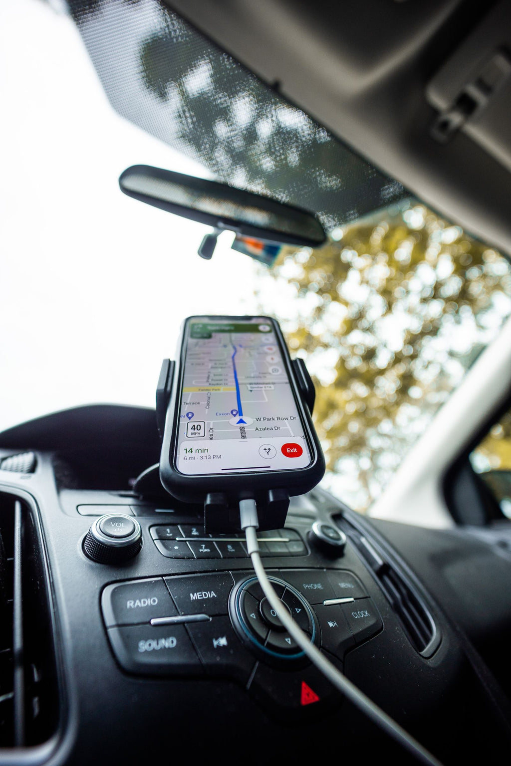 Smartphone mounted on car dashboard with navigation