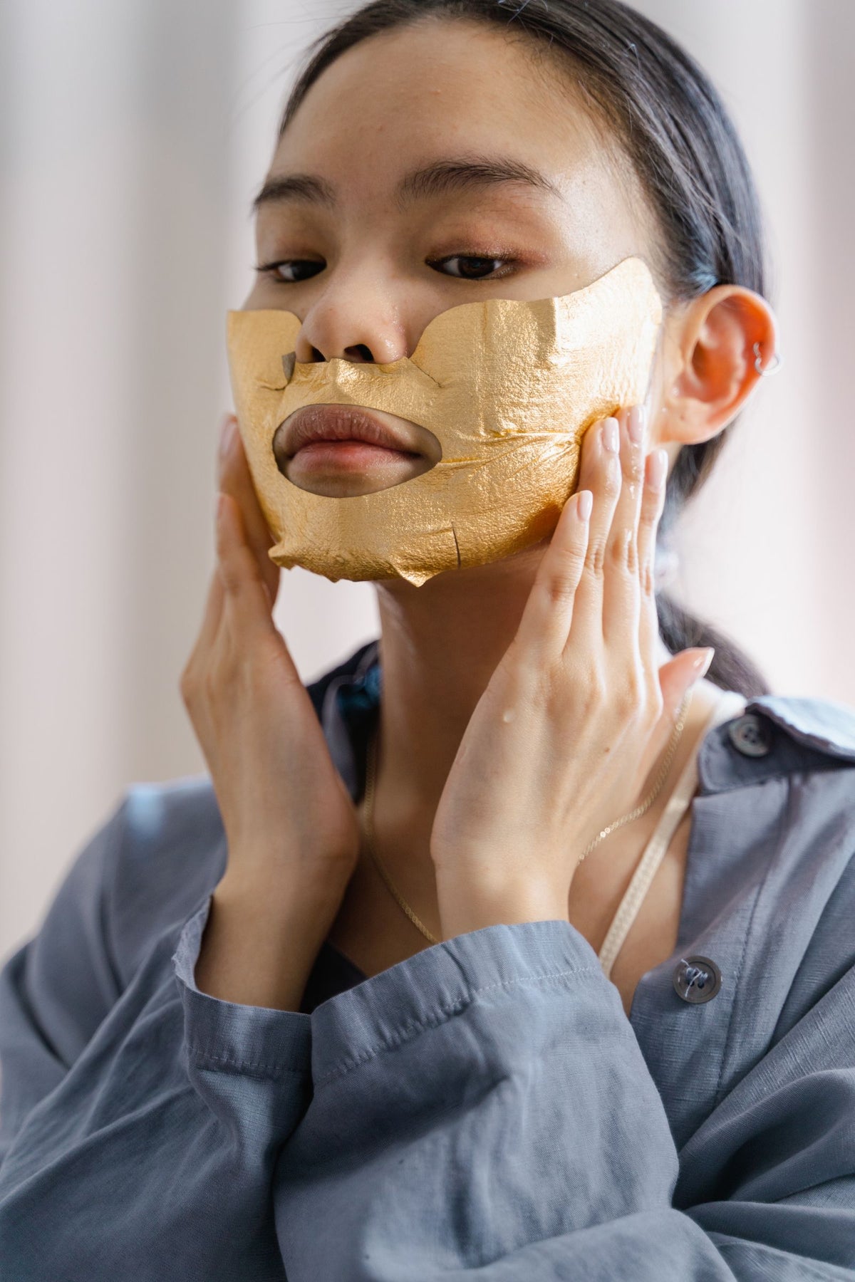 Woman applying luxurious facial mask for beauty routine