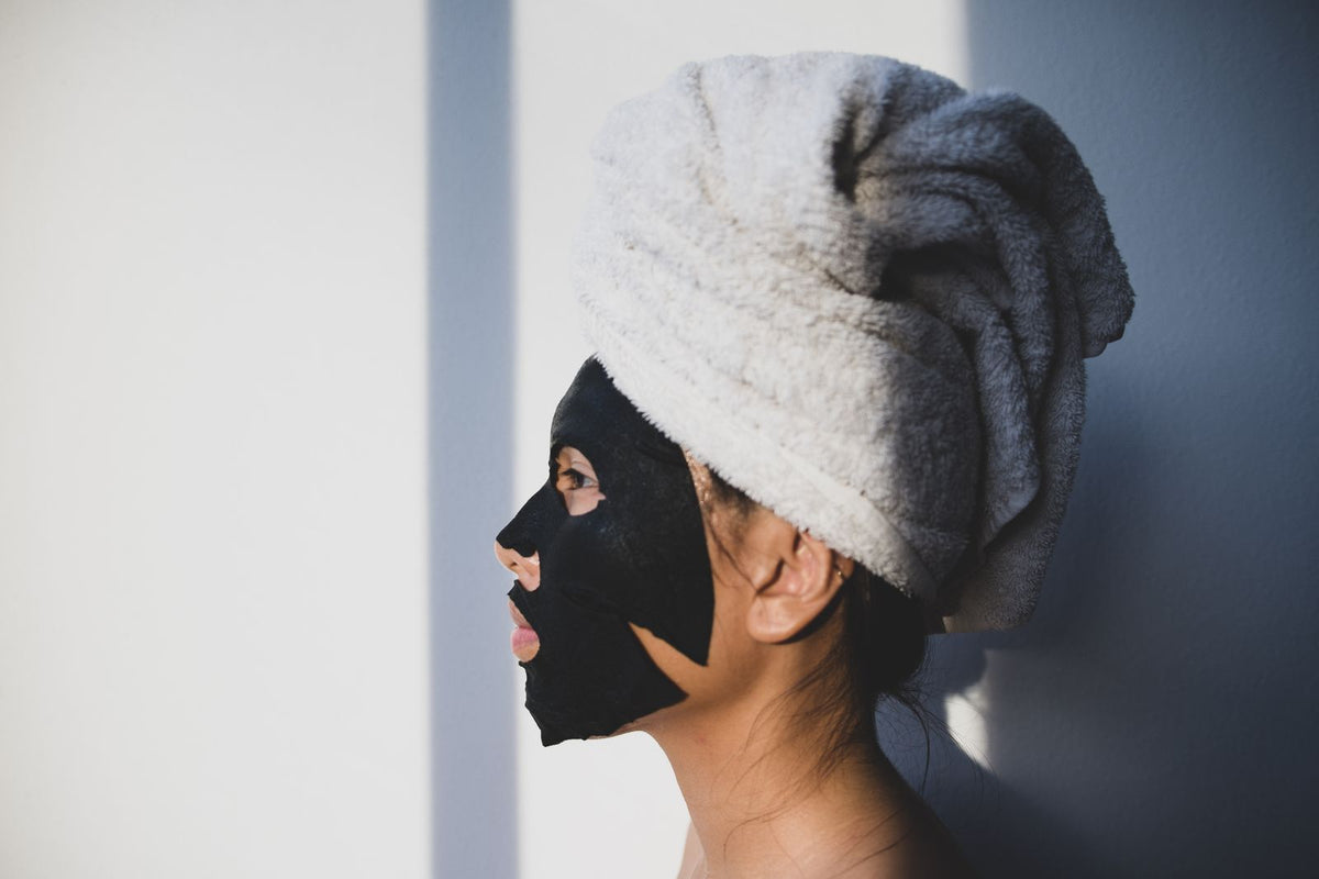 Woman with facial mask skincare ritual