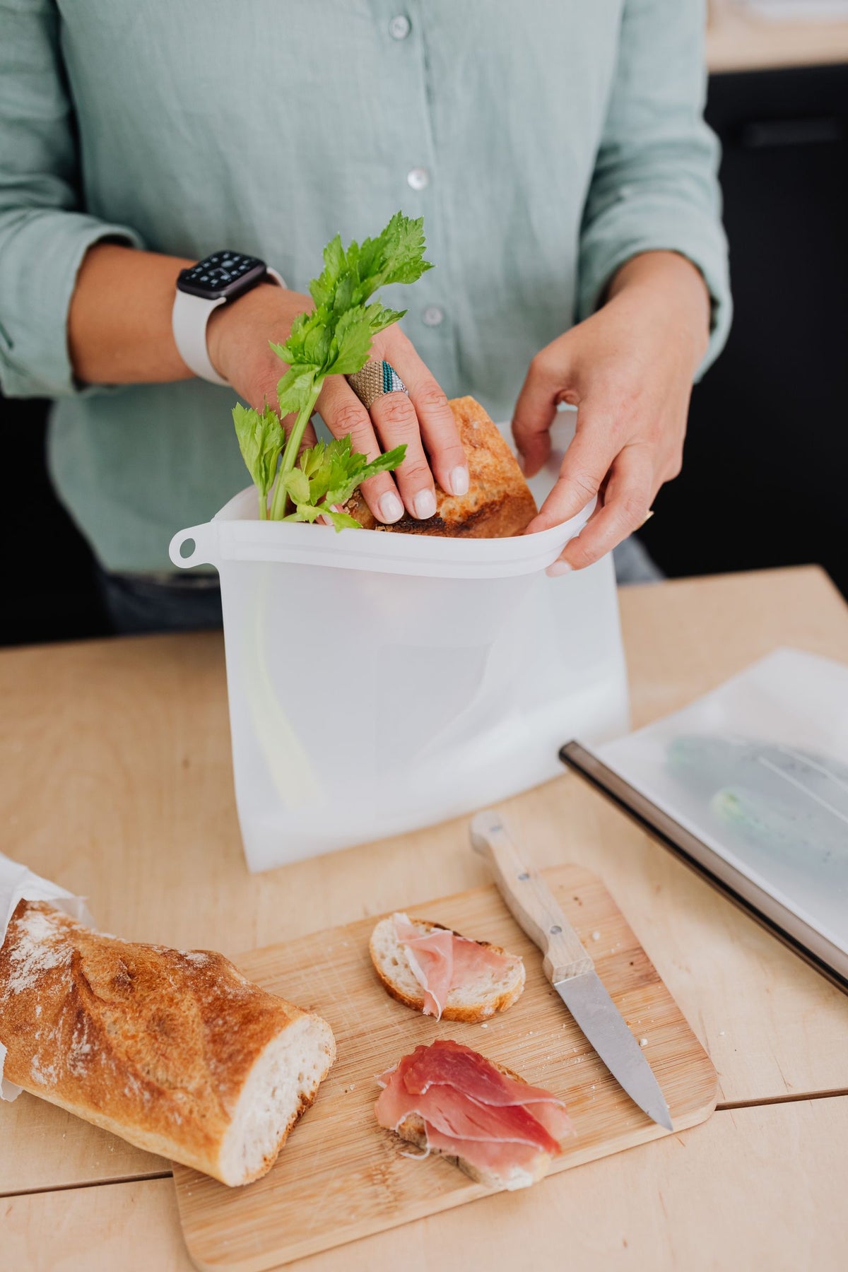 Packing bread into a leakproof reusable silicone food storage bag