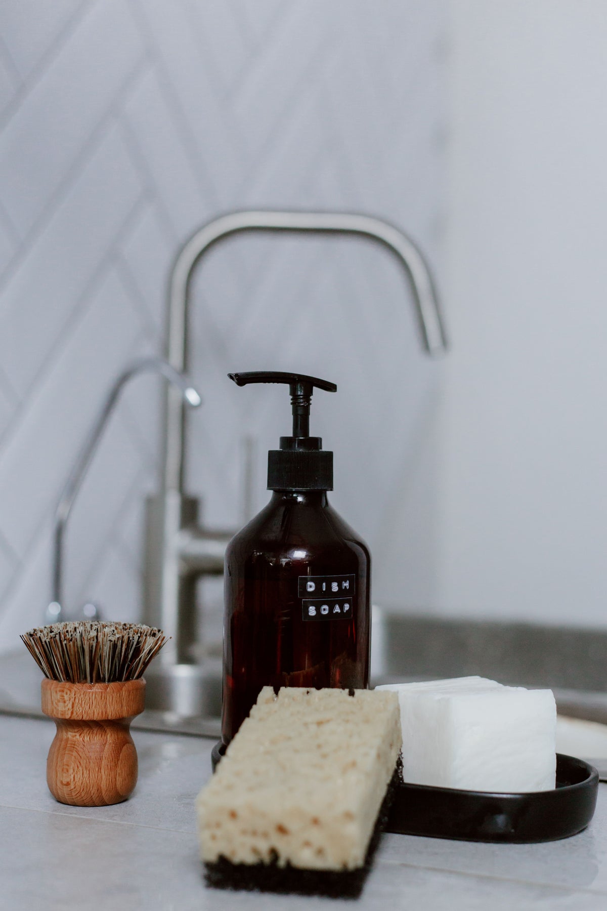Kitchen sink caddy keeping soap and brushes organized on the counter