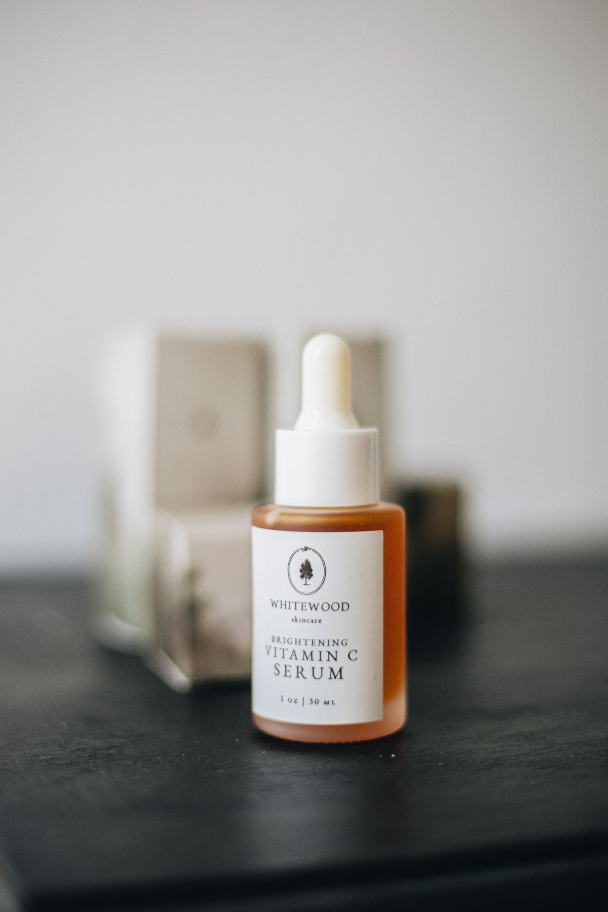 Vitamin C brightening face serum bottle with a glass dropper